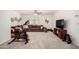 Spacious living room featuring a sectional sofa and an exercise area with stationary bike at 17753 W Columbine Dr, Surprise, AZ 85388