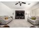 Comfortable living area features neutral decor, large screen TV, and ceiling fan at 17753 W Columbine Dr, Surprise, AZ 85388