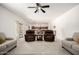 Bright living room with neutral tones, plush seating, and an open layout to the kitchen at 17753 W Columbine Dr, Surprise, AZ 85388