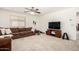 Bright living room featuring a comfortable sofa, television, and fitness equipment at 17753 W Columbine Dr, Surprise, AZ 85388