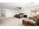Bright main bedroom with a ceiling fan and cozy sitting area at 17753 W Columbine Dr, Surprise, AZ 85388