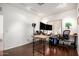 Bright office space with hardwood flooring, ample natural light, and a modern desk setup for productivity at 17753 W Columbine Dr, Surprise, AZ 85388