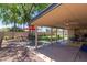 Large covered patio and backyard with an outdoor seating area and well-maintained lawn at 1953 E Laguna Dr, Tempe, AZ 85282