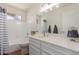 Bright bathroom featuring a tub with shower, sleek vanity, and a large mirror offering plenty of natural light at 1953 E Laguna Dr, Tempe, AZ 85282