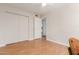 Spacious bedroom featuring a large closet and laminate flooring with a view into the kitchen at 1953 E Laguna Dr, Tempe, AZ 85282