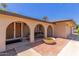 Charming entryway with arched openings, brick accents, and a cozy bench for relaxing outdoors at 1953 E Laguna Dr, Tempe, AZ 85282
