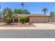 Charming single-story home featuring a well-manicured lawn, mature trees, and a spacious two-car garage at 1953 E Laguna Dr, Tempe, AZ 85282