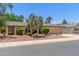Inviting single-story home with desert landscaping, mature trees, and an attached two-car garage at 1953 E Laguna Dr, Tempe, AZ 85282