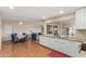 Open concept living and dining area with views to kitchen, featuring laminate floors and bright, natural light at 1953 E Laguna Dr, Tempe, AZ 85282