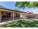 Inviting backyard patio featuring an outdoor dining area and a covered seating area, perfect for entertaining guests at 1953 E Laguna Dr, Tempe, AZ 85282