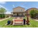 Expansive backyard with lush artificial turf, paved patio, and charming bench seating for outdoor enjoyment at 198 E Patton Ave, Coolidge, AZ 85128