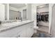 Well-lit bathroom featuring double sinks with granite countertops and a walk-in closet for ample storage at 198 E Patton Ave, Coolidge, AZ 85128