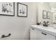 Elegant powder room features stylish decor and a modern black faucet, creating a sophisticated ambiance at 198 E Patton Ave, Coolidge, AZ 85128