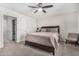 Relaxing bedroom with a ceiling fan, a spacious bed, and a view into the connected bathroom for added convenience at 198 E Patton Ave, Coolidge, AZ 85128