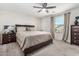 Bright bedroom with large bed, ceiling fan, dresser, and bedside table, creating a comfortable retreat at 198 E Patton Ave, Coolidge, AZ 85128