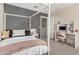 Charming bedroom featuring a four-poster bed, a desk area with storage, and soft, inviting decor at 198 E Patton Ave, Coolidge, AZ 85128