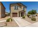 Inviting two-story home with a well-kept lawn and desert landscaping enhances curb appeal at 198 E Patton Ave, Coolidge, AZ 85128