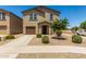 Inviting two-story home featuring a well-maintained yard and a one car attached garage at 198 E Patton Ave, Coolidge, AZ 85128