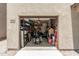 Spacious garage interior with ample storage shelves and a motorcycle, perfect for hobbyists and organization at 198 E Patton Ave, Coolidge, AZ 85128