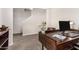 Home office features stylish desk with wood-look tile flooring at 198 E Patton Ave, Coolidge, AZ 85128