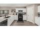 Well-lit kitchen with white cabinets, modern appliances, and backsplash at 198 E Patton Ave, Coolidge, AZ 85128
