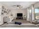 Spacious living room with decorative curtains, modern ceiling fan, and wood-look tile flooring at 198 E Patton Ave, Coolidge, AZ 85128