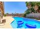 Inviting backyard with a private pool, mature palm trees, and an outdoor dining set for relaxation at 2031 W Gila Ln, Chandler, AZ 85224