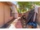 Cozy backyard featuring a brick path, mature tree and block wall at 2031 W Gila Ln, Chandler, AZ 85224