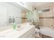 Bathroom featuring tiled walls, large mirror over vanity, tub and shower with curtain at 2031 W Gila Ln, Chandler, AZ 85224
