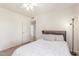 Bright bedroom featuring a light ceiling fan, neutral walls, and carpet at 2031 W Gila Ln, Chandler, AZ 85224