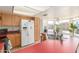 Spacious kitchen with wood cabinetry, stainless steel sink, and a breakfast bar at 2031 W Gila Ln, Chandler, AZ 85224