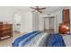 Cozy main bedroom with light wood floors, ceiling fan, ensuite bathroom, and ample closet space at 2031 W Gila Ln, Chandler, AZ 85224
