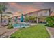 Spacious backyard with in-ground pool, grass lawn, and desert landscaping with privacy fence at 21167 E Aspen Valley Dr, Queen Creek, AZ 85142