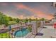 Balcony view with in-ground pool, desert landscaping, golf course, and sunset sky at 21167 E Aspen Valley Dr, Queen Creek, AZ 85142