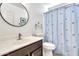 Bright bathroom with a single sink vanity and a shower with a blue floral curtain at 21167 E Aspen Valley Dr, Queen Creek, AZ 85142