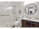 Well-lit bathroom features a walk-in shower with white tile and a vanity with dark cabinetry at 21167 E Aspen Valley Dr, Queen Creek, AZ 85142