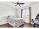 Bright bedroom with a ceiling fan and neutral walls and dark floors at 21167 E Aspen Valley Dr, Queen Creek, AZ 85142