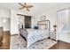 Primary bedroom with an decorative bed, dark wood floors and a sliding barn door at 21167 E Aspen Valley Dr, Queen Creek, AZ 85142