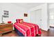 Bright bedroom featuring a twin bed and wooden dresser with dark laminate flooring at 21167 E Aspen Valley Dr, Queen Creek, AZ 85142