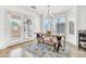 Bright dining area with a rustic wooden table, comfortable bench seating, and ample natural light at 21167 E Aspen Valley Dr, Queen Creek, AZ 85142