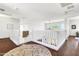 Bright upstairs hallway with white railings and dark hardwood floors with a decorative area rug at 21167 E Aspen Valley Dr, Queen Creek, AZ 85142