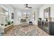 Cozy living room showcasing a comfortable chair, stylish rug, and plenty of natural light streaming through the windows at 21167 E Aspen Valley Dr, Queen Creek, AZ 85142