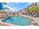 Beautiful in-ground pool with stone waterfall feature, tanning ledge, built-in grill and desert landscaping at 21167 E Aspen Valley Dr, Queen Creek, AZ 85142