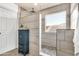 Modern tiled shower with rain showerhead, pebble floor, and privacy window at 21167 E Aspen Valley Dr, Queen Creek, AZ 85142
