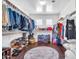Spacious walk-in closet with ample storage, wood floor, clothing racks, shelving, and decorative rug at 21167 E Aspen Valley Dr, Queen Creek, AZ 85142