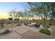 Lush backyard seating area with native desert plants and gravel for low-maintenance landscaping at 21934 E Lords Ct, Queen Creek, AZ 85142