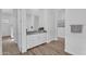 Bathroom featuring granite countertop with white cabinets and light wood-look flooring at 21934 E Lords Ct, Queen Creek, AZ 85142