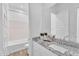 Bright bathroom with granite countertops, a large mirror, and a tub with shower at 21934 E Lords Ct, Queen Creek, AZ 85142