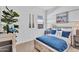 Well-lit bedroom featuring nautical accents, a decorative potted plant, and wooden decor at 21934 E Lords Ct, Queen Creek, AZ 85142