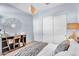 Well-lit bedroom with an artistic wall mirror, a storage unit, and double closets at 21934 E Lords Ct, Queen Creek, AZ 85142